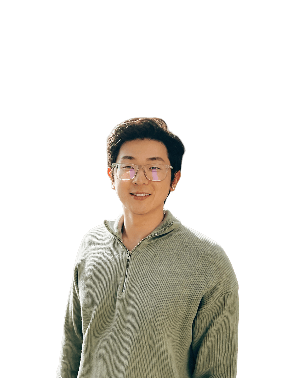 Brian Noh smiling in a green sweater